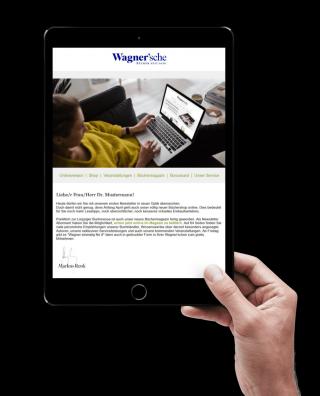 Frau hält ein Tablet in den Händen mit dem Newsletter der Wagnerschen.